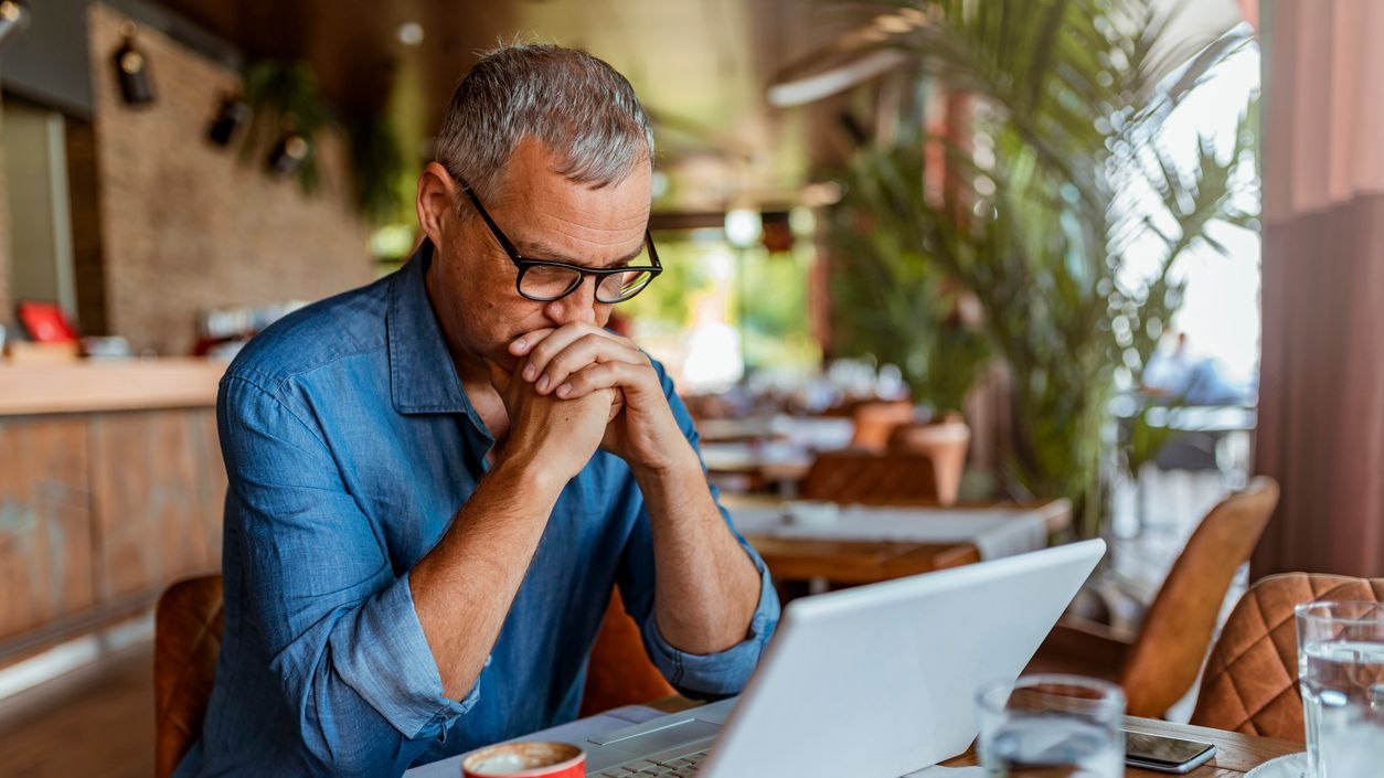 A man who spent decades working at a company that recently declared bankruptcy looks over the pension benefits he will receive.